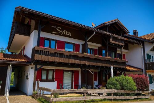 a building with a sign on the side of it at Haus Sylta in Fischen