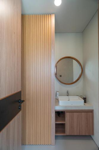 a bathroom with a sink and a mirror at Tuspa Ubud Villa in Ubud