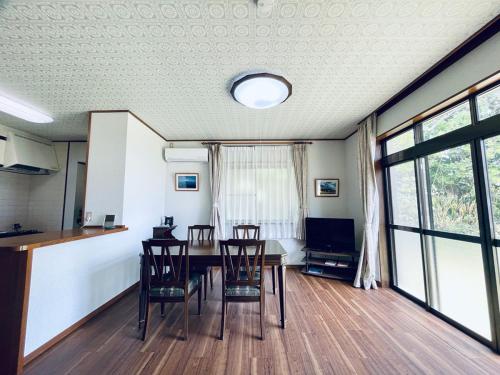 a dining room with a table and chairs at TheOceanVilla Sole in Oshima