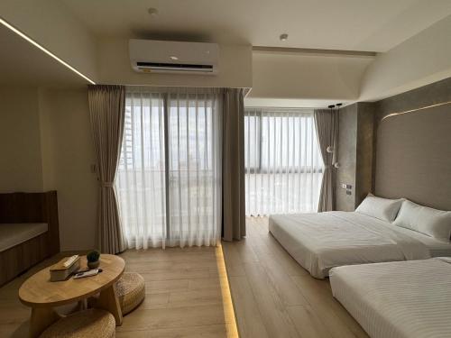 a hotel room with two beds and a table at 留亦晚 in Toucheng