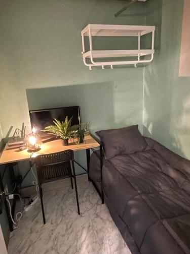 a bedroom with a bed and a desk with a computer at Raon House Paju in Paju