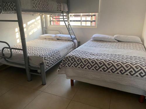 Ένα ή περισσότερα κρεβάτια σε δωμάτιο στο Maktub Casa AcaCancún