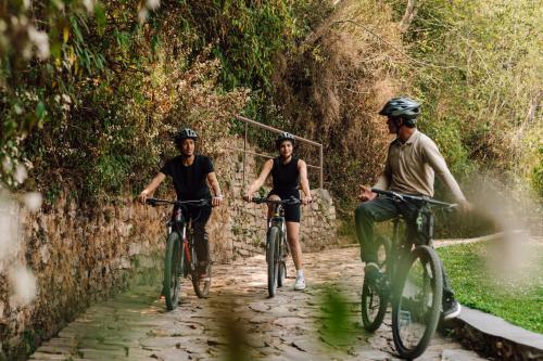 a group of three people riding bikes down a path at Kavya Himalayas in Nagarkot