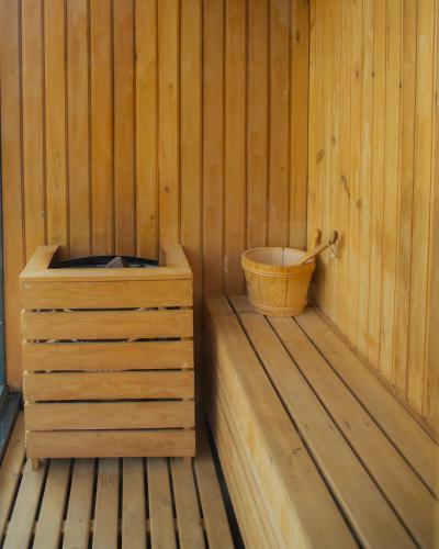 a wooden cabin with a bucket in the corner at Kavya Himalayas in Nagarkot