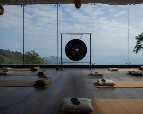 a room with yoga mats in front of a large window at Kavya Himalayas in Nagarkot