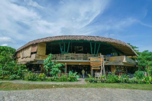 a large building with a large roof at Balai Adlao in El Nido