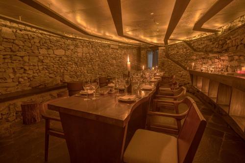 a long dining room with a long table and chairs at Kavya Himalayas in Nagarkot