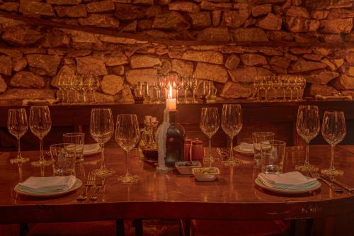 a table with wine glasses and a bottle on it at Kavya Himalayas in Nagarkot