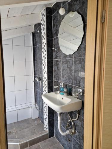 a bathroom with a sink and a mirror at Maraki in Thymonia Beach
