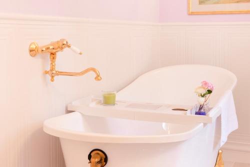 a bathroom with a white sink with a candle at VILLA TOJI luxury private in Bracciano