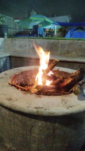a fire is burning in a stone oven at Maktub TlayaGlamping in Tlayacapan