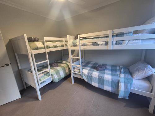 a room with two bunk beds and a room with at The Coastal Crab, Moonta Bay in Port Moonta