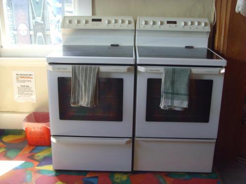 two white ovens sitting next to each other in a kitchen at Big Tree Lodge Methven in Methven