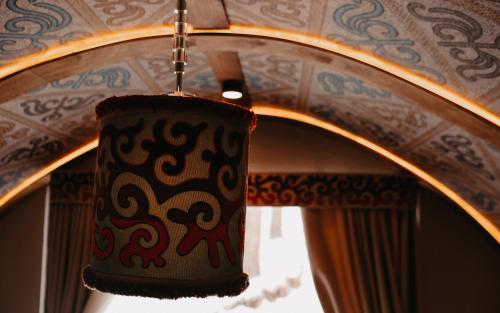 a chandelier hanging in front of a mirror at Supara Chunkurchak in Alamedin