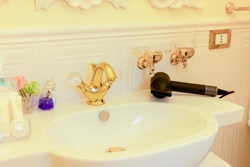 a bathroom sink with a blow dryer on top of it at VILLA TOJI luxury private in Bracciano