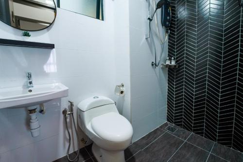 a bathroom with a toilet and a sink and a mirror at Horizon Ipoh 8Pax 3R2B - Tropical Bird's Retreat in Ipoh