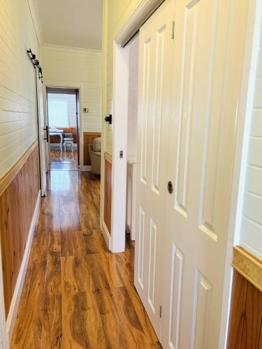 a hallway of a home with wooden floors and a door at 3-Bedroom Blue Mountains Hideaway in Central Katoomba in Katoomba