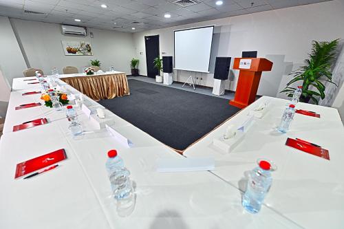a conference room with white tables with water bottles on it at Ewan Ajman Suites Hotel in Ajman 