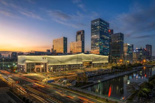 a city skyline with a large building and a river at The Azure Ningbo, Vignette Collection in Ningbo
