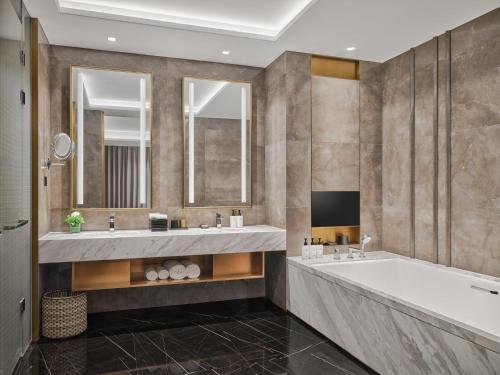 a large bathroom with two sinks and a tub at The Azure Ningbo, Vignette Collection in Ningbo