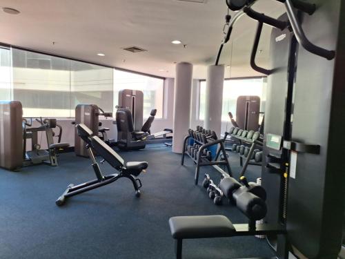 a gym with treadmills and ellipticals in a building at Residence on Langley Park in Perth