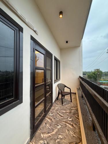 a chair sitting on the balcony of a house at Hotel ILIKA in Bhopal
