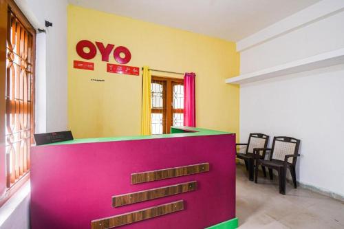 a room with a colorful counter and chairs in it at Hotel O Purple Inn Bahadalpur Railway Station in Bhubaneshwar