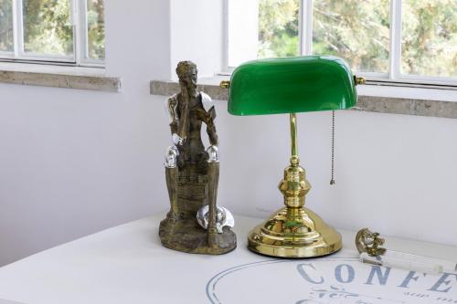 a statue and a green lamp on a table at VILLA TOJI luxury private in Bracciano