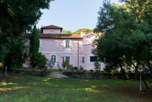a large white house with a tower on top of it at VILLA TOJI luxury private in Bracciano