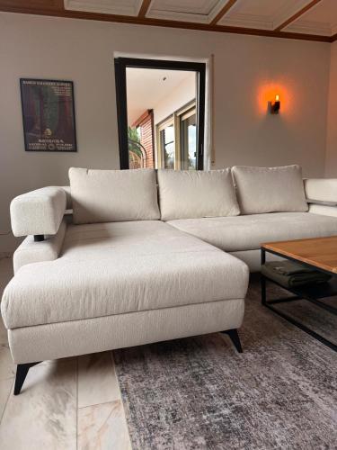 a living room with a couch and a table at Private Spa Lodge Odenwald in Lindenfels
