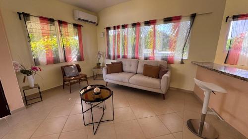 a living room with a couch and a table at Caleton Group in Río San Juan