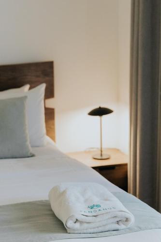 a white towel is laying on a bed at Pandanus Palms Holiday Resort in Point Lookout