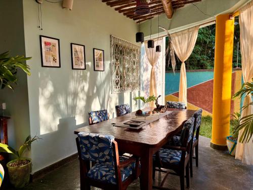 a dining room with a wooden table and chairs at Casa Hera Diani in Diani Beach
