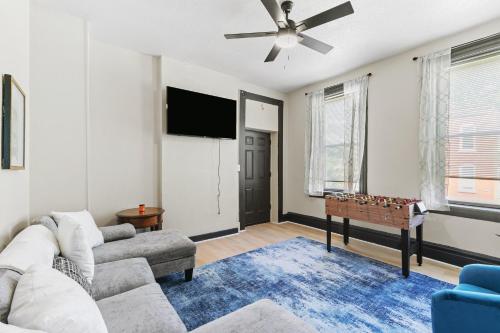 a living room with a couch and a flat screen tv at 2BD Flat Near Cherokee Arts with Game Room vibes! in Saint Louis