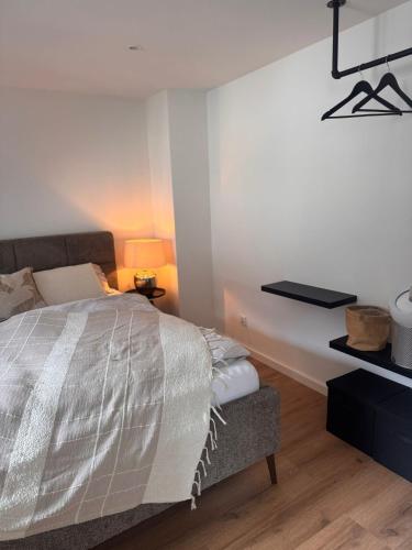 a bedroom with a bed and a table and a lamp at theroof in Bremm