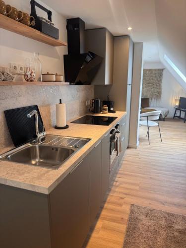 a kitchen with a sink and a counter top at theroof in Bremm