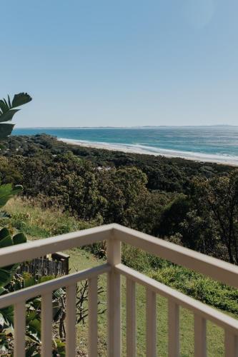 a view of the beach from the balcony of a house at Pandanus Palms Holiday Resort in Point Lookout