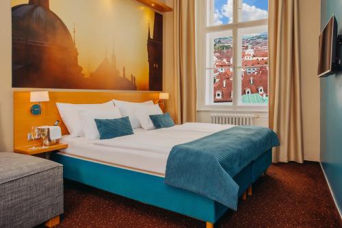 a hotel room with a bed and a window at Hotel Adler - Czech Leading Hotels in Prague