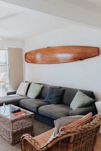 a living room with a couch and a table at Pandanus Palms Holiday Resort in Point Lookout