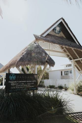 a building with a sign in front of it at Pandanus Palms Holiday Resort in Point Lookout