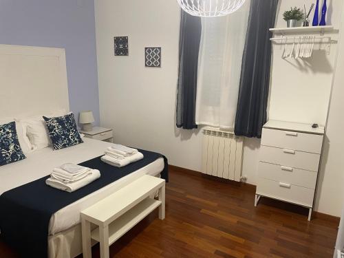 a bedroom with a bed and a dresser and a window at BeB L'ALLORO in Pachino
