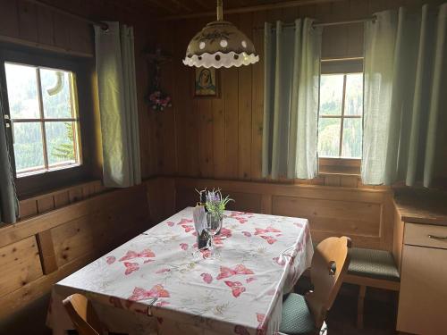 a dining room with a table with flowers on it at Lanzer Obheimat in Außervillgraten