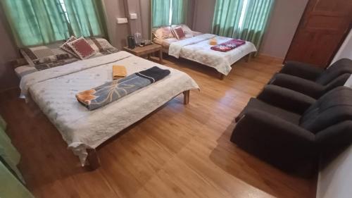 a living room with two beds and a couch at NA I BARIT EC homestay in Mawlynnong