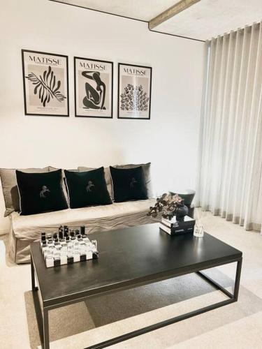 a living room with a couch and a coffee table at Black Diamond by ParberyProperty in Kingston 
