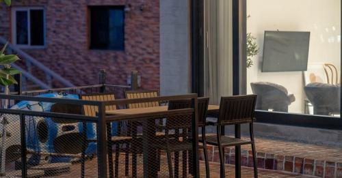 a wooden table and chairs on a patio at Gangneung Terramomum in Gangneung