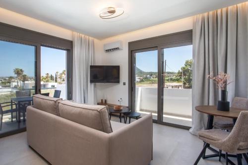a living room with a couch and a table at Nostos Luxury Apartments in Kremasti