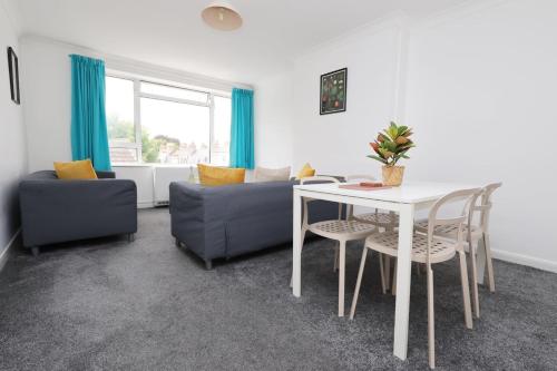 a living room with a table and a couch at Central Bath Getaway with WiFi in Bath