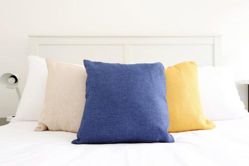 a bunch of pillows sitting on a bed at Central Bath Getaway with WiFi in Bath