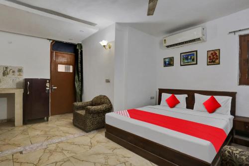 a bedroom with a bed and a chair in it at Hotel O by OYO TSA in New Delhi