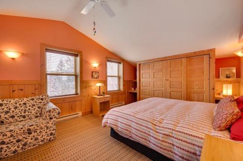 a bedroom with a bed and a couch in it at Domaine Bonheura - Spa & Swimming Pool in Val-David